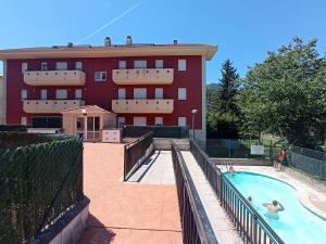 a building with a swimming pool in front of a building at APARTAMENTO LAS FRAGUAS in Ampuero