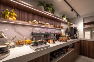 a kitchen with a counter with food on it at ONE TWO FOUR - Hotel & Spa in Ghent