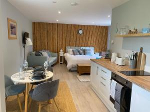 a kitchen and living room with a bed and a table at Sandy Top in Saint Abbs