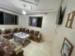a living room with a couch and a table at Bahia beach . Plage dahomey in Bouznika +5 photos