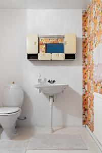 a bathroom with a toilet and a sink and a mirror at Villa nära Varberg och Ullared in Varberg