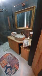 a bathroom with a sink and a mirror at Apartment in city center in Przemyśl +7 photos