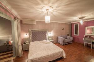 a bedroom with a bed and a chair in it at Delphi Art Hotel by Prima Hotels in Athens