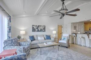 a living room with a couch and a ceiling fan at Lagoon Villa 22 - Private Villa! Close Walk to Beach! in Isle of Palms