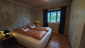 a bedroom with a bed and a window at Moen Booking in Åndalsnes