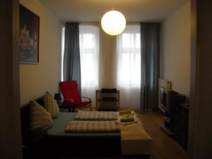 a living room with a couch and a tv at Pension Mitte in Berlin