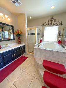 a large bathroom with a tub and a sink at The Inn at 37 Main in Rockville