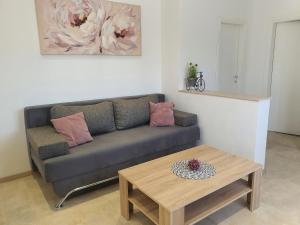 a living room with a couch and a coffee table at Apartment Radoš in Dugopolje