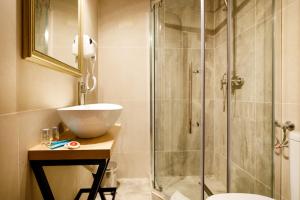 a bathroom with a sink and a glass shower at La Colțul Castelului Bran Boutique in Bran +79 photos