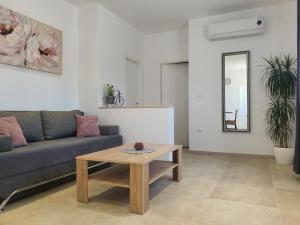 a living room with a couch and a coffee table at Apartment Radoš in Dugopolje