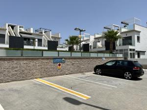 a car parked in a parking lot next to a building at Modern Studio Lamar Resort in Pilar de la Horadada