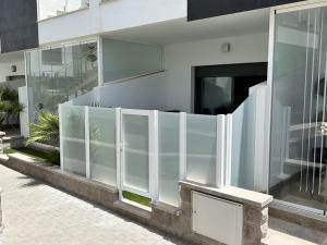 a facade of a building with a white fence at Modern Studio Lamar Resort in Pilar de la Horadada +7 photos