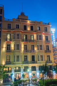 a large building in front of a building at Delphi Art Hotel in Athens