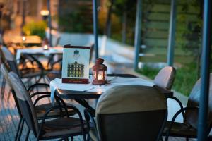 a table with a book and a candle on it at Delphi Art Hotel by Prima Hotels in Athens