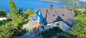 an aerial view of a large house with the water at Bergen sunrise Apartment - self check in - Free Parking in Bergen