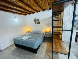 a bedroom with a bed and a glass staircase at Monoambientes El viejo Olivo in Villa Unión