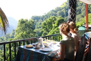 a group of people sitting at a table on a balcony at Different View in Ella
