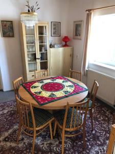 a dining room table with chairs and a rug on it at Domek Maxov - Ubytování v srdci Jizerských hor. in Lučany nad Nisou