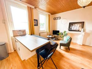 a kitchen with a large island in a room at II-Charmant Appartement au coeur de la ville in Guingamp