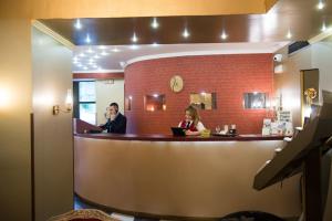 a man and a woman sitting at a bar at Delphi Art Hotel by Prima Hotels in Athens