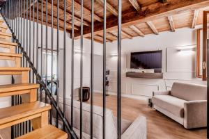 a living room with a staircase and a couch at APT ROME - Vittoria Palace in Rome
