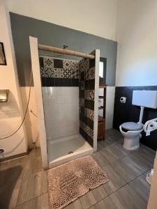 a bathroom with a shower and a toilet at Belvedere Kale' in Santa Marinella