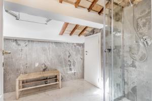 a bathroom with a walk in shower and a bench at APT ROME - Vittoria Palace in Rome +37 photos