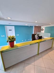 una recepción en una oficina con una maceta en Marina Bezerril - 303 Pontamares - O melhor de Natal, en Natal 23 fotos más