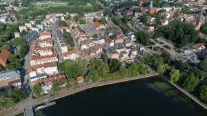 an aerial view of a town next to a body of water at Ostróda City Center PKO lake apartments balcony in Ostróda