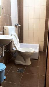 a bathroom with a toilet and a sink at Struga-Rooms/Dhoma/Sobi in Struga