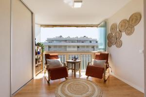 a room with chairs and a table and a large window at Great location! Walking distance to everything! in Fuengirola