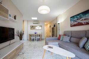a living room with a couch and a table at Great location! Walking distance to everything! in Fuengirola