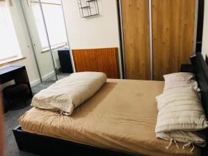 a bed with two pillows on it in a room at Holiday inn house in Longton