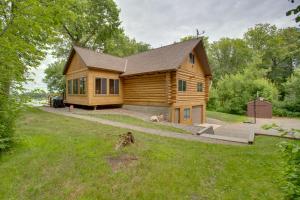 een blokhut met een hond ervoor bij Lakefront Cabin Retreat, 2-Acre Lot with Deck! 