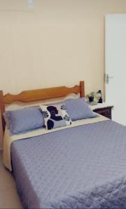 a bedroom with a bed with a cow pillow on it at Casa do Mirante in Petrópolis