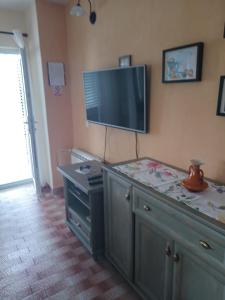 a living room with a tv on the wall at Apartment Seget Vranjica 1051b in Seget Vranjica