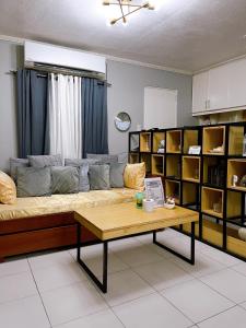 a living room with a couch and a coffee table at The Doll House 1 in Orani
