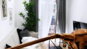 a living room with a couch and a window at Bilbao Ronda apartamento con balcón Casco Viejo in Bilbao
