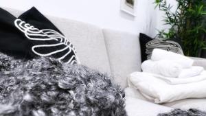 a living room with black and white pillows on a couch at Bilbao Ronda apartamento con balcón Casco Viejo in Bilbao