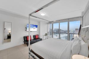 a bedroom with a bed and a large window at Highest floor Icon W Brickell Location in Miami