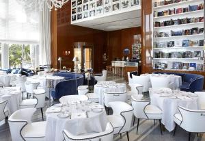 a dining room with white tables and white chairs at Highest floor Icon W Brickell Location in Miami