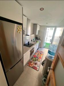 a kitchen with a refrigerator and a sink at apartment in Valencia