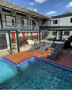 a swimming pool with a deck and a building at Living Hotel São Paulo in Sao Paulo