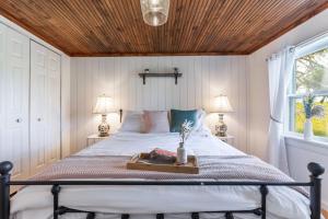 a bedroom with a bed with a wooden ceiling at Unique Stay! Ricketts Chic Farmhouse Retreat with Stargazing Bubble Tent 