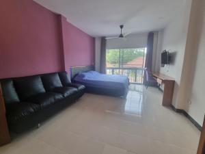 a living room with a couch and a bed at Eldorado pool villa 6br in Jomtien Beach