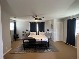 a bedroom with a bed and a ceiling fan at Split level 4blocks from rt 66-hot tub - EV charger - firepit in Williams
