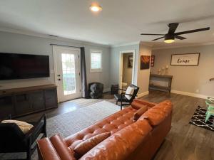 a living room with a couch and a flat screen tv at Split level 4blocks from rt 66-hot tub - EV charger - firepit in Williams