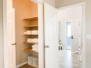 a room with a closet with white doors and towels at Hibiscus Hale, Full Kitchen, King Bed, Parking in Keaau +23 photos