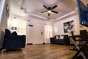 a living room with a ceiling fan and a couch at Chic & Cozy 2 bedroom - 1 bathroom - RATED BEST in Eagle Pass