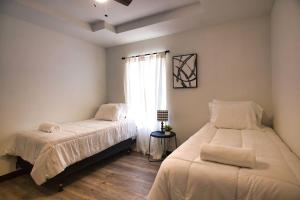 a bedroom with two beds and a window at Chic & Cozy 2 bedroom - 1 bathroom - RATED BEST in Eagle Pass